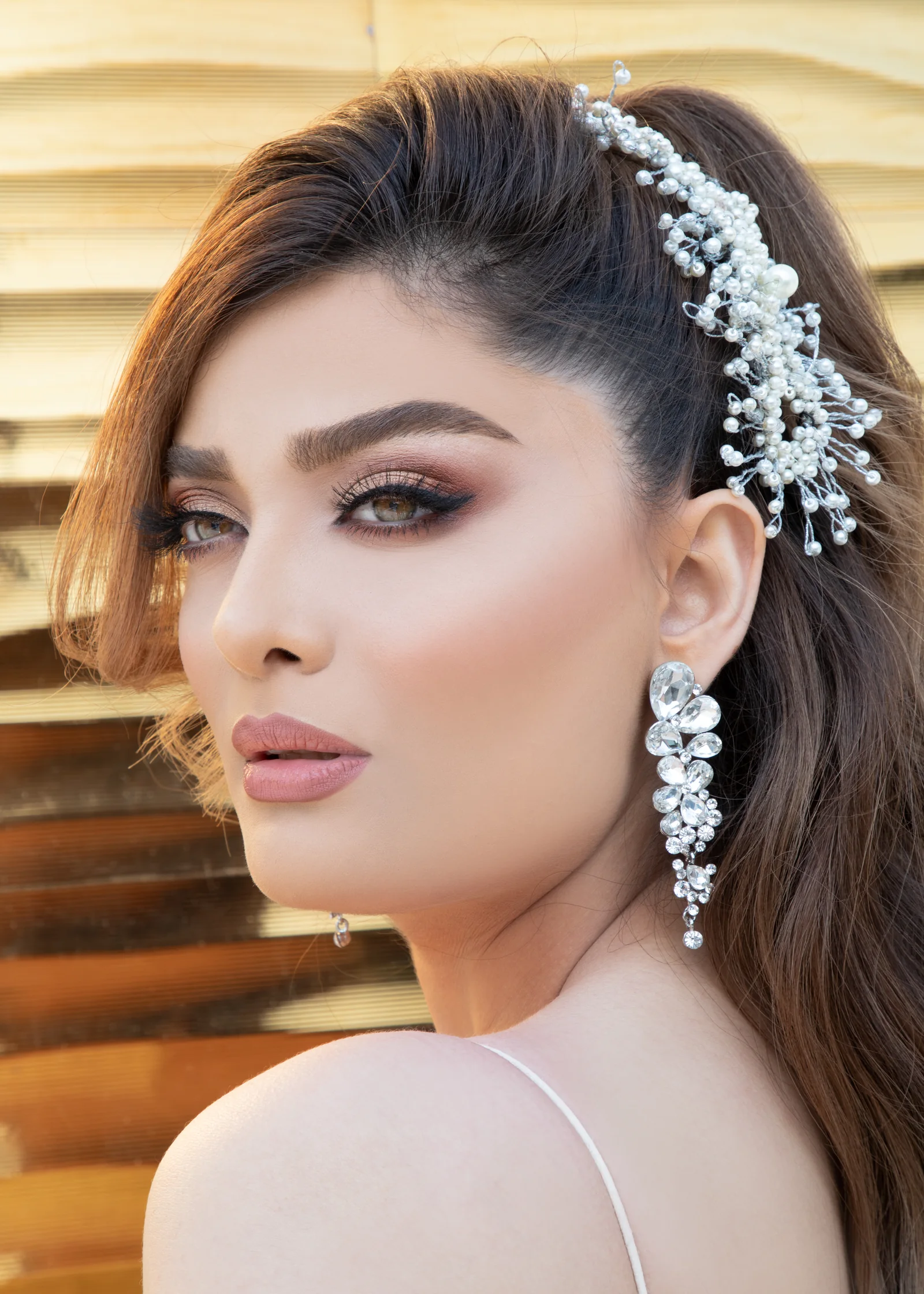 Elegant bridal makeup by Haleh Ahmadi in Vancouver with a jewelled hairpiece and warm luminous skin